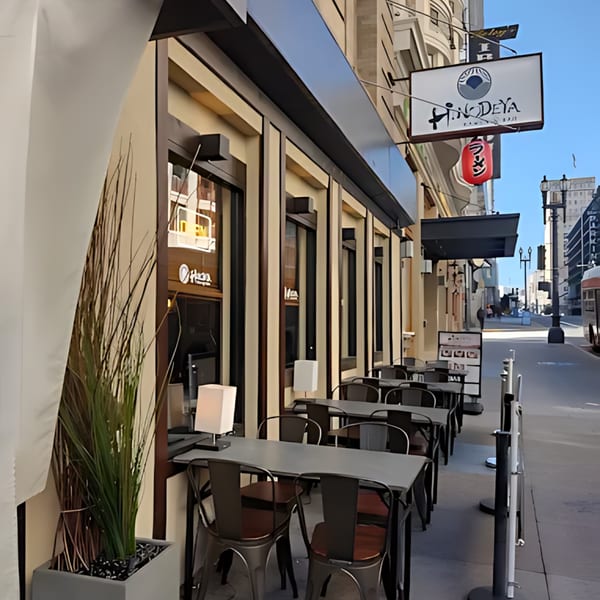 HINODEYA Ramen restaurant exterior with outdoor seating, a red lantern, and a street view.
