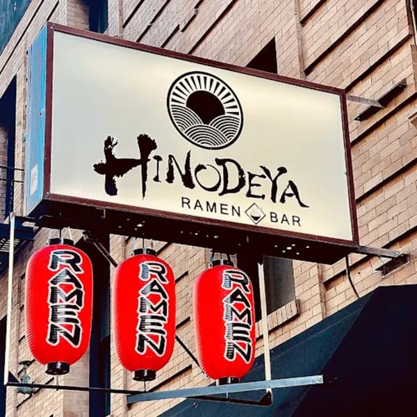 HINODEYA Ramen Bar sign with a sun logo and three red lanterns displaying "RAMEN".