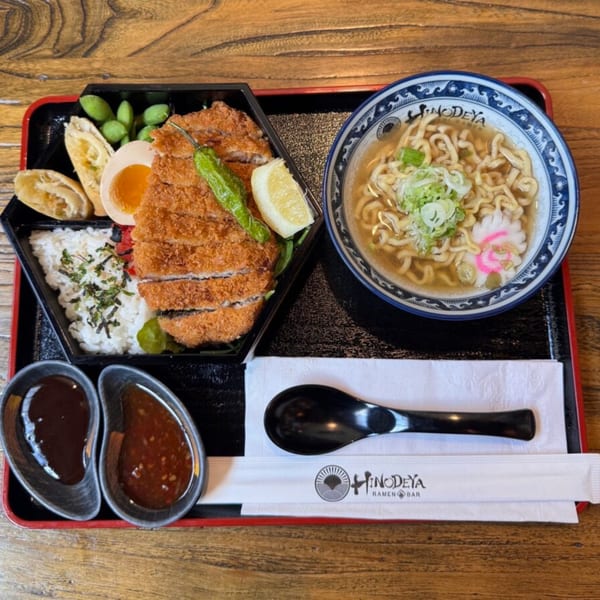 HINODEYA Ramen bento box with tonkatsu, rice, edamame, egg, and a bowl of ramen.